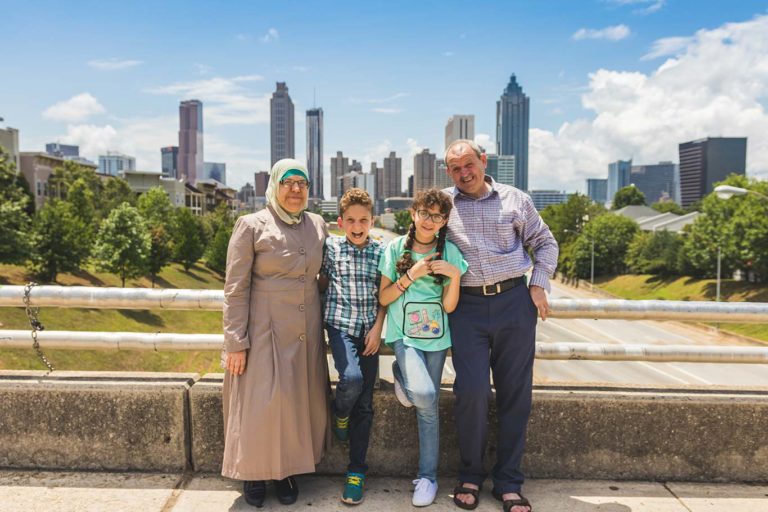 The Bassout family in front of the Atlanta skyline