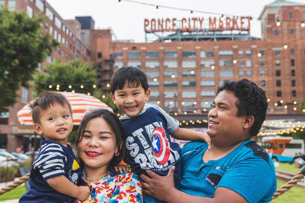 The Suk Rai family in front of Ponce City Market building