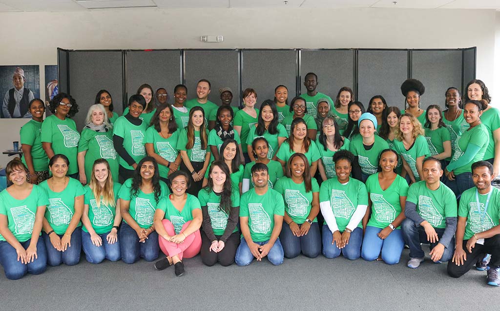 New American Pathways staff photo in their green Georgia shirts